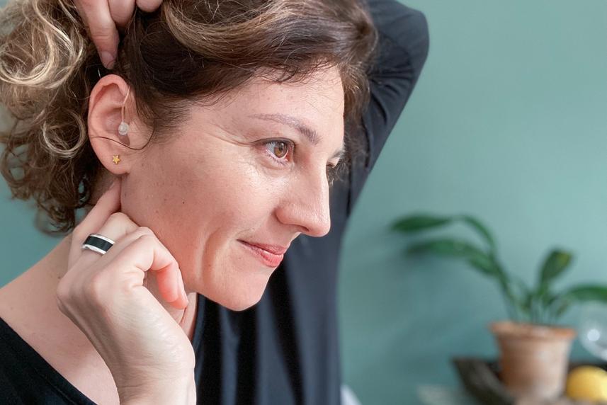 Woman feeling behind her ear