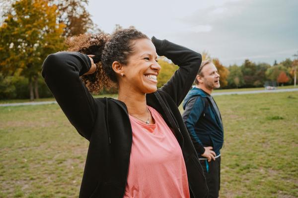 Two people outside, smiling to the side