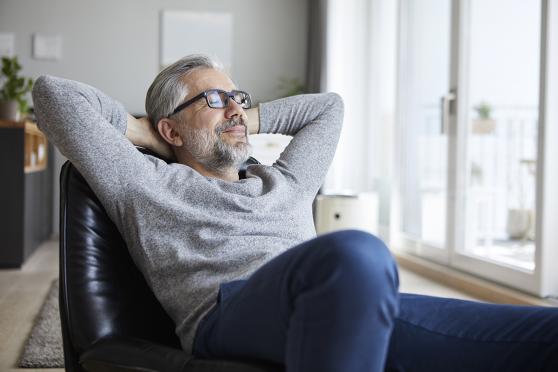 A man leaning back, relaxing in a chair